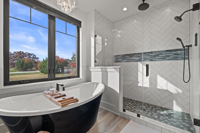 bathroom with separate shower and tub and hardwood / wood-style floors