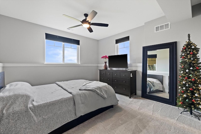 bedroom featuring ceiling fan and light carpet