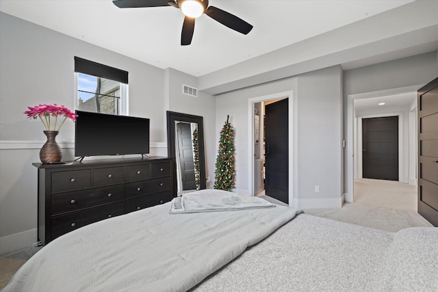 bedroom featuring ceiling fan and light carpet