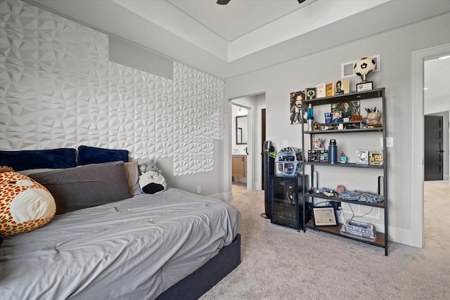 carpeted bedroom with ceiling fan and connected bathroom