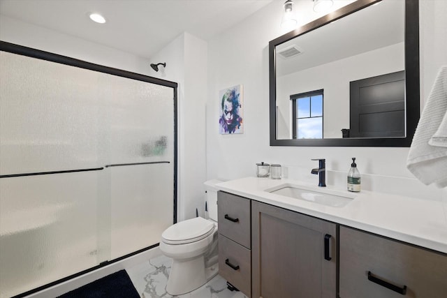 bathroom with an enclosed shower, vanity, and toilet