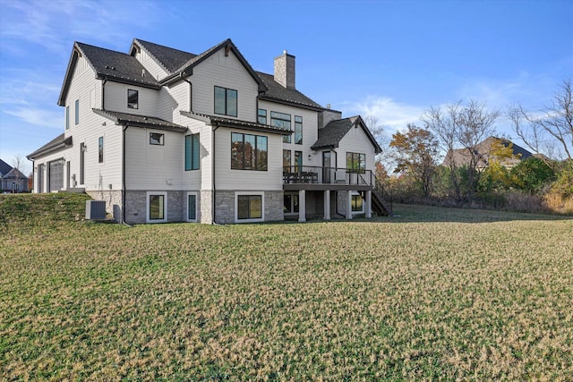 back of house with a lawn, a deck, and central air condition unit