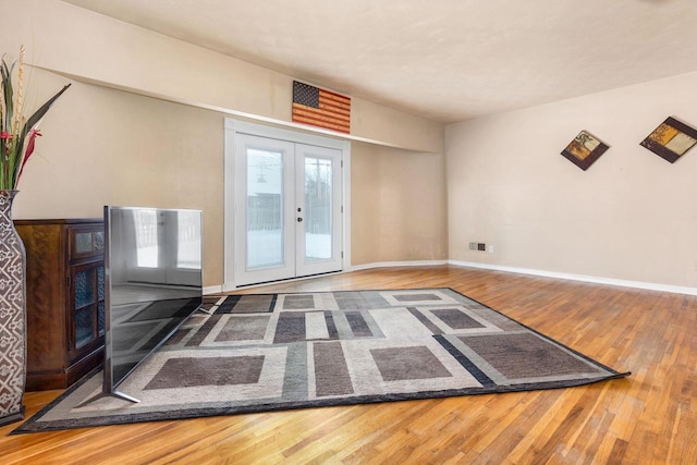 interior space with wood-type flooring and french doors