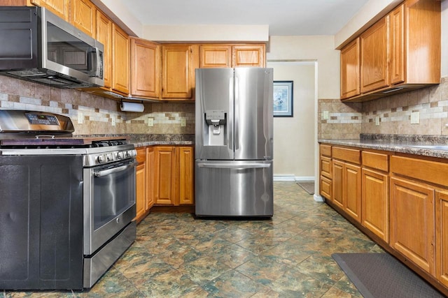 kitchen featuring stainless steel appliances and decorative backsplash