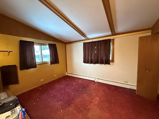 spare room with dark colored carpet, lofted ceiling, and a baseboard heating unit