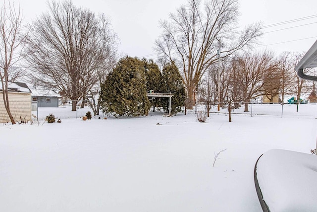 yard layered in snow with fence