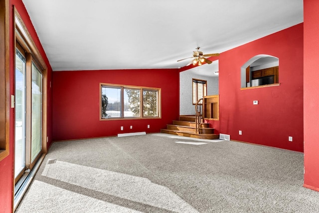 carpeted empty room featuring ceiling fan and vaulted ceiling