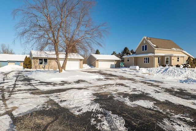 view of front of house featuring a garage and an outdoor structure