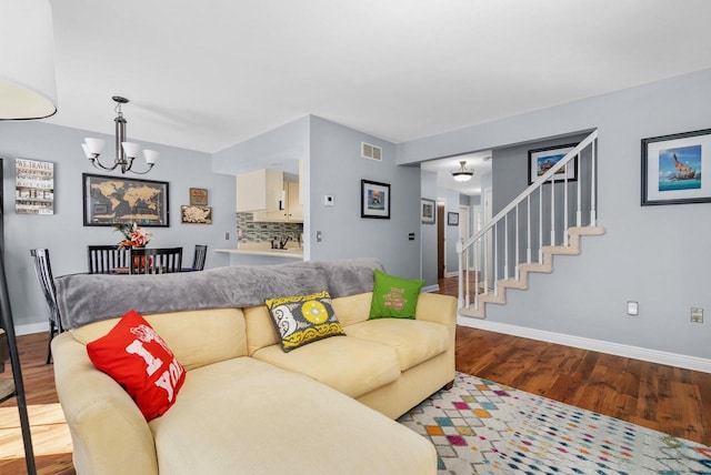 living room featuring a chandelier and hardwood / wood-style floors