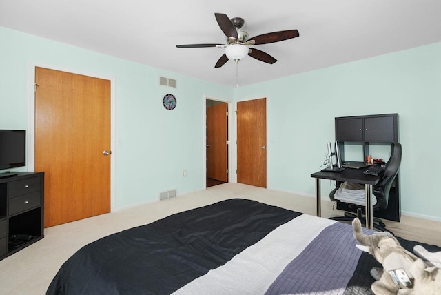 bedroom with ceiling fan and light carpet