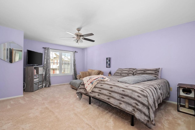 bedroom featuring ceiling fan and light carpet