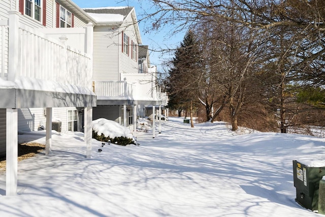 yard layered in snow featuring a balcony