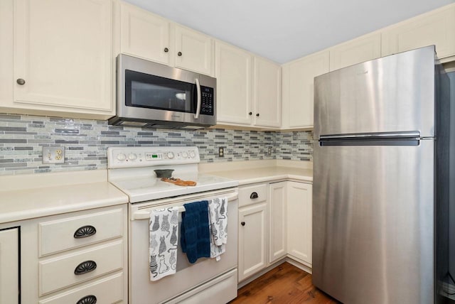 kitchen with tasteful backsplash, stainless steel appliances, and dark hardwood / wood-style flooring