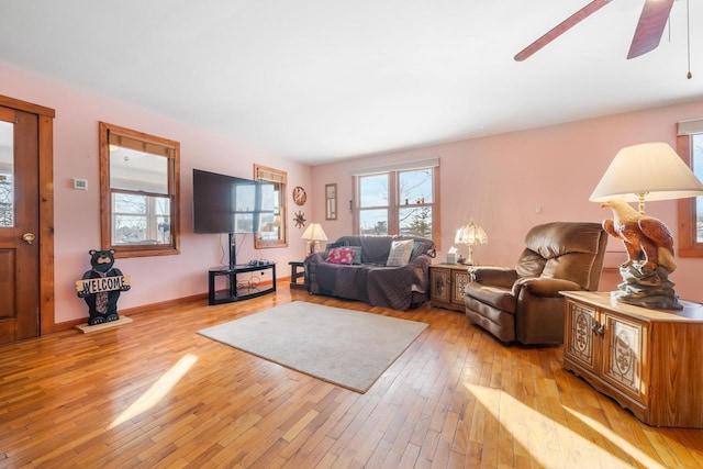 living room featuring ceiling fan and light wood-type flooring