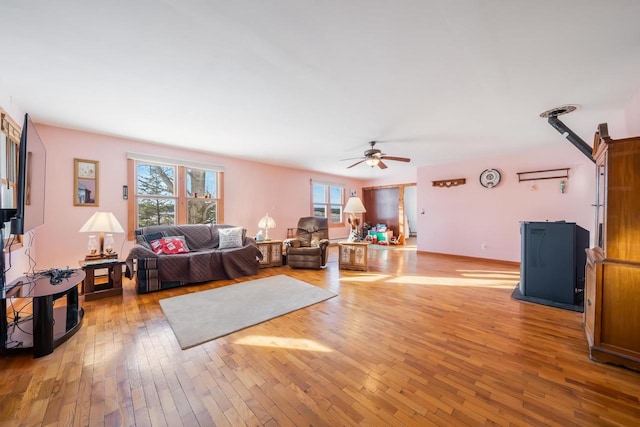 living room featuring ceiling fan and light hardwood / wood-style flooring