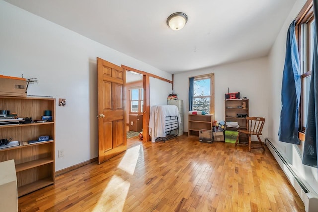 interior space featuring light wood-type flooring and a baseboard radiator