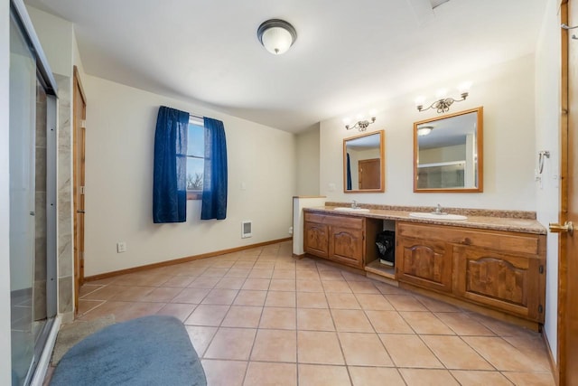 bathroom featuring tile patterned floors, an enclosed shower, and vanity