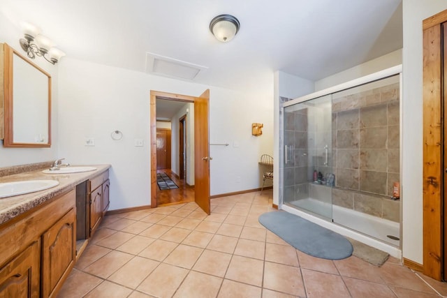 bathroom featuring tile patterned flooring, vanity, and a shower with door