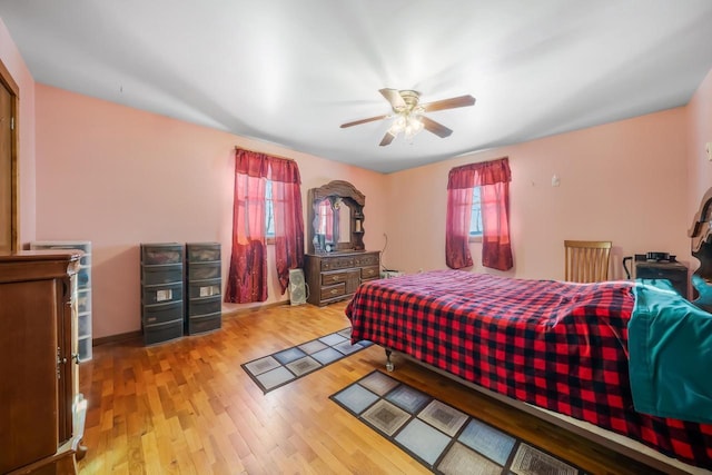 bedroom with light wood-type flooring and ceiling fan