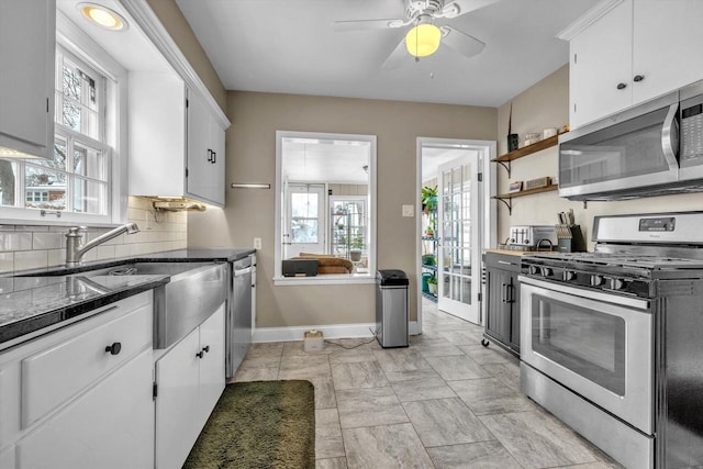 kitchen featuring white cabinets, stainless steel appliances, and decorative backsplash