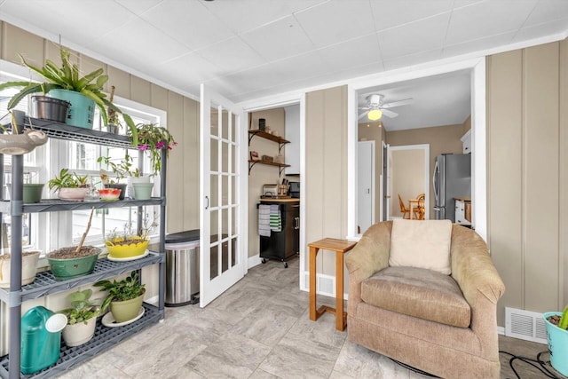 living area with a healthy amount of sunlight and ceiling fan