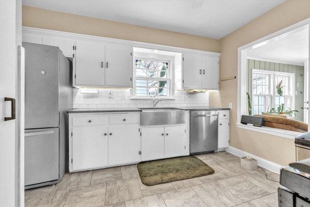 kitchen with white cabinetry, stainless steel appliances, plenty of natural light, and sink