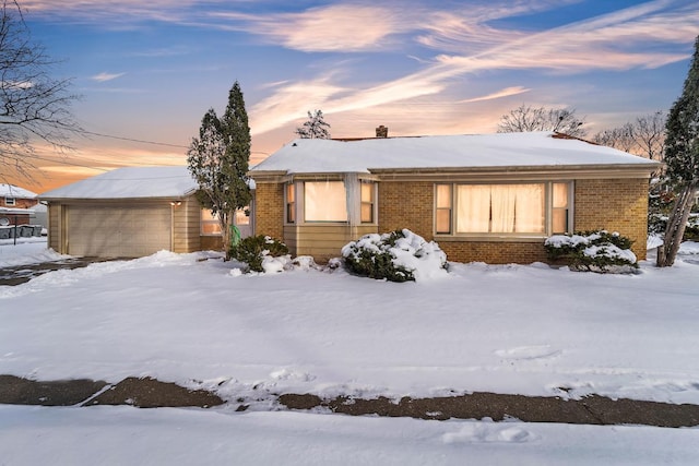 view of front of property featuring an attached garage and brick siding