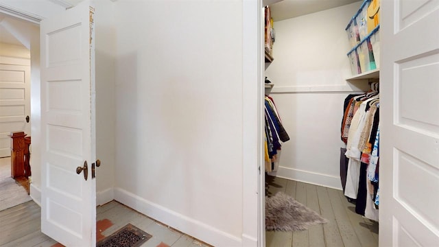 walk in closet featuring light hardwood / wood-style floors