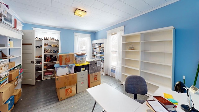 home office with dark wood-type flooring and ornamental molding