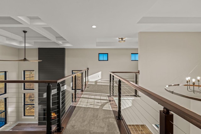 hall featuring beam ceiling, wood-type flooring, and coffered ceiling