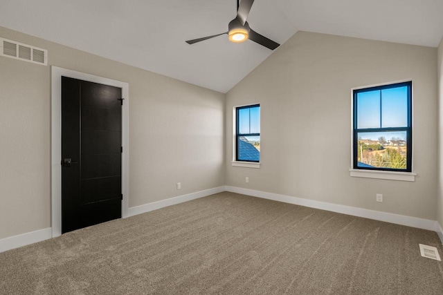 empty room featuring carpet floors, lofted ceiling, and ceiling fan