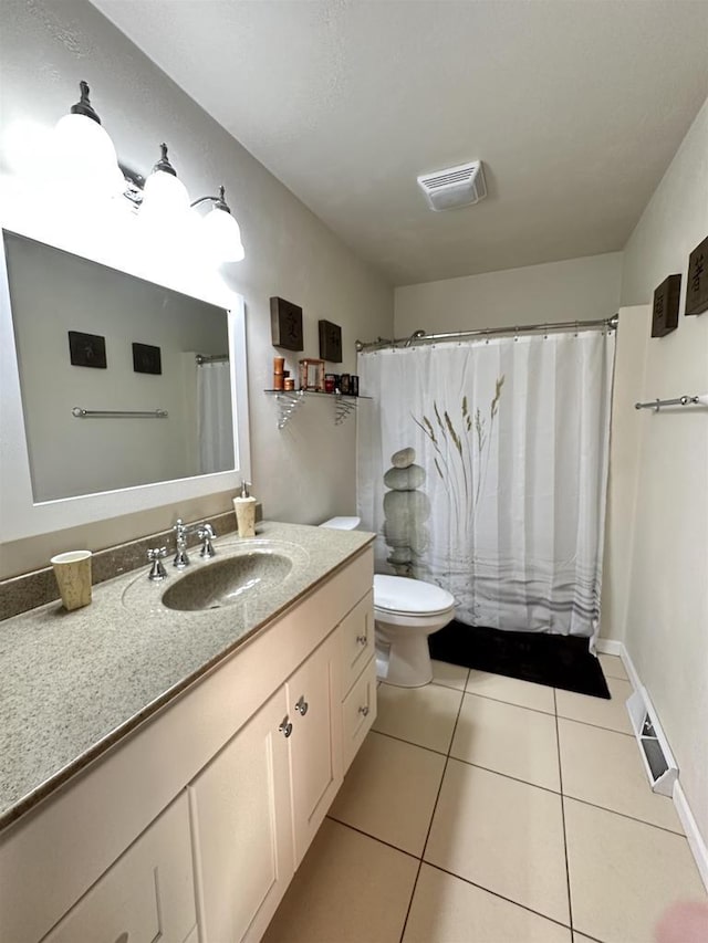 bathroom with a shower with curtain, vanity, tile patterned flooring, and toilet