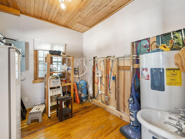 bathroom featuring electric water heater, lofted ceiling, wood ceiling, hardwood / wood-style floors, and sink