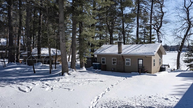 view of snow covered back of property