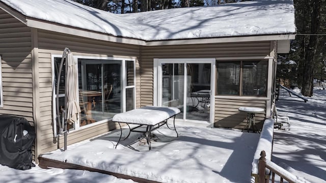 snow covered patio with a grill