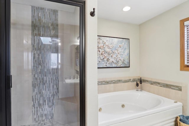 full bathroom with a jetted tub, a stall shower, and recessed lighting