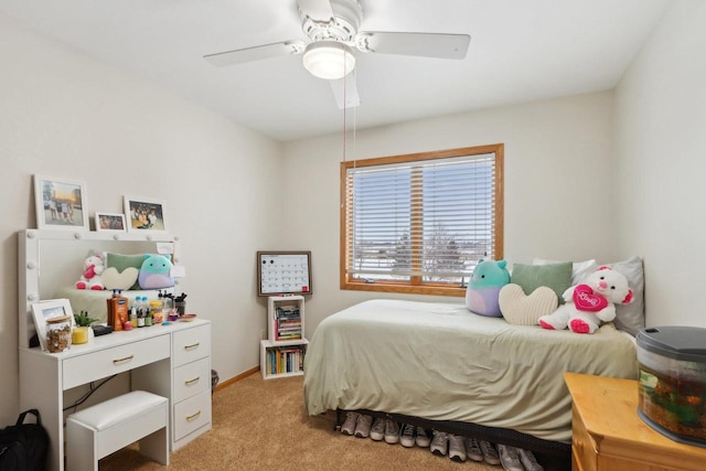 bedroom featuring light carpet, ceiling fan, and baseboards