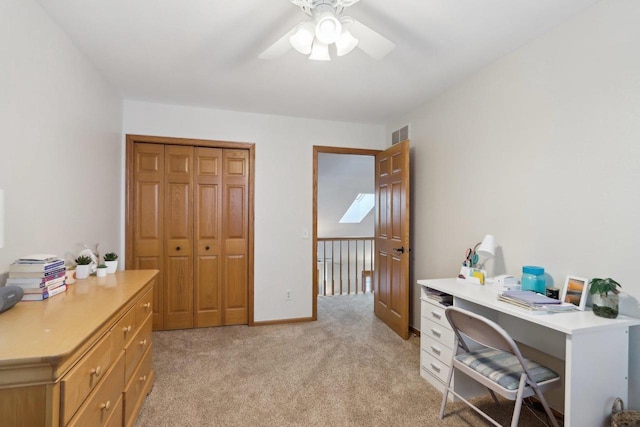 office featuring visible vents, ceiling fan, light carpet, and baseboards