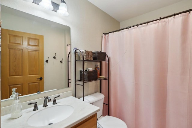 bathroom with toilet and vanity