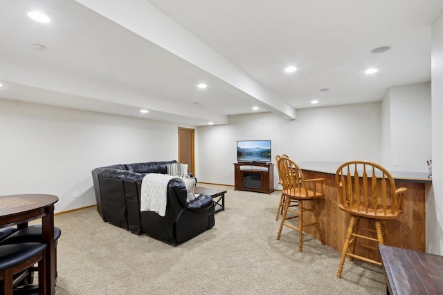 living area featuring a bar, recessed lighting, baseboards, and light colored carpet