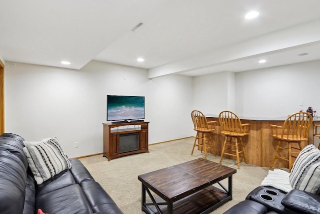 living room featuring recessed lighting, light carpet, a fireplace, visible vents, and a bar