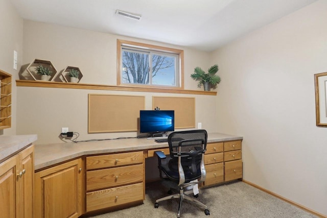 office area with light carpet, visible vents, and baseboards