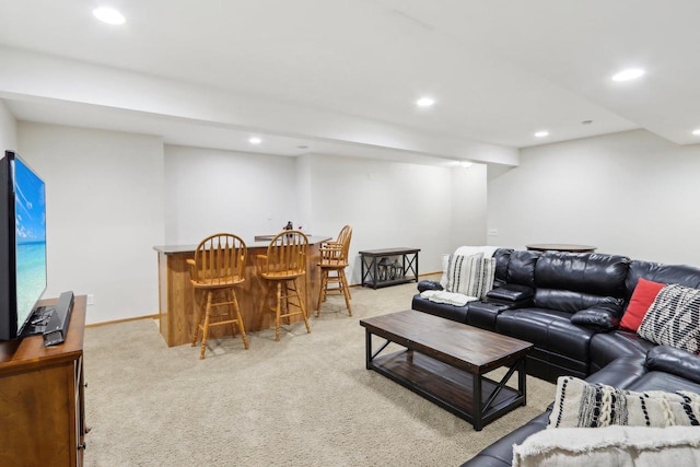 living area featuring baseboards, a bar, recessed lighting, and light colored carpet