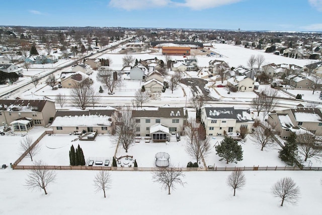 snowy aerial view featuring a residential view