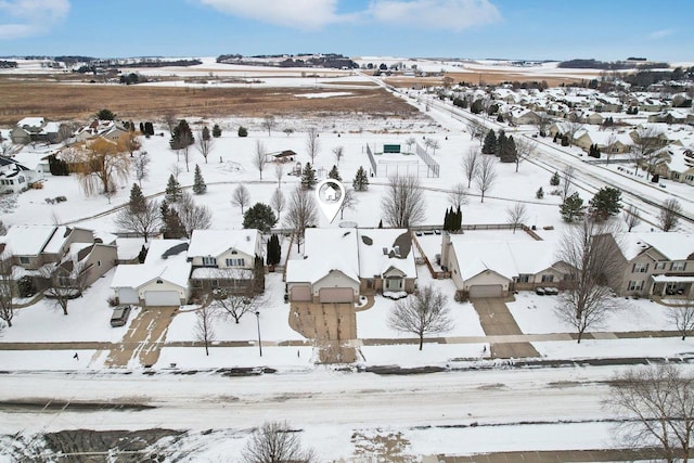 snowy aerial view featuring a residential view