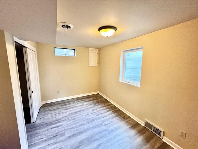 interior space with dark wood-type flooring and a healthy amount of sunlight