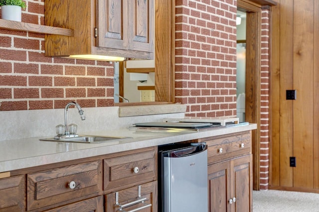 kitchen with sink, carpet flooring, and tasteful backsplash