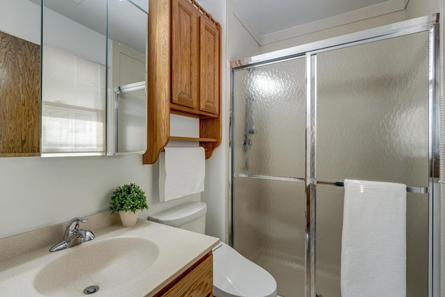 bathroom with toilet, an enclosed shower, and vanity