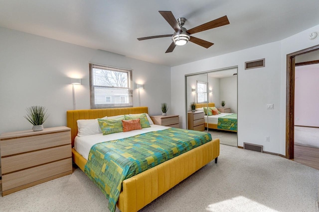 carpeted bedroom featuring a closet and ceiling fan