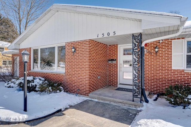 view of snow covered property entrance